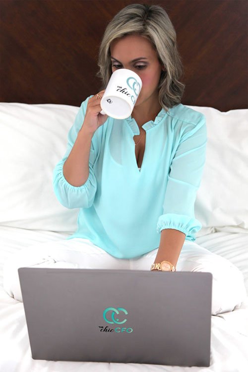 Denai Wolfe with cup and laptop in bed